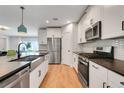 Modern kitchen with a farmhouse sink, stainless steel appliances, and breakfast bar at 678 Blackstone St, Minneola, FL 34715