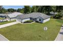 Inviting one story home with a well-manicured lawn, showcasing its curb appeal at 8635 Se 156 St, Summerfield, FL 34491