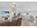 Spacious living room with vaulted ceiling open to the kitchen and dining area at 8635 Se 156 St, Summerfield, FL 34491