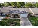 Aerial view of a cozy home featuring a charming front porch and a well-manicured lawn at 8738 Sw 95Th Ln # B, Ocala, FL 34481