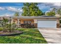 Single-story home featuring an attached garage, cozy front porch, and lovely curb appeal at 8738 Sw 95Th Ln # B, Ocala, FL 34481