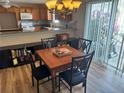 Cozy dining room with chandelier and hardwood floors adjoins the kitchen, perfect for Gathering meals at 8932 Se 168Th Sedgwick Pl, The Villages, FL 32162