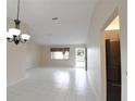 Open living area with tile flooring, a chandelier, and a view to the entryway at 10442 Se 179Th Pl, Summerfield, FL 34491