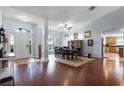Open-concept entryway showing dining room, hardwood floors, and natural light at 11126 Oakshore Ln, Clermont, FL 34711