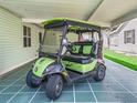 Carport featuring a green and black golf cart with stylish rims under a covered parking area at 1202 Del Toro Dr, Lady Lake, FL 32159