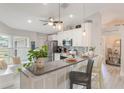 Modern eat-in kitchen featuring stainless appliances, stylish pendant lights, and a breakfast bar at 12401 Blue Heron Way, Leesburg, FL 34788