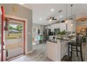 Bright and airy kitchen featuring stainless steel appliances, counter seating, and plenty of natural light at 12401 Blue Heron Way, Leesburg, FL 34788