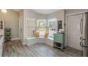 Cozy kitchen nook with bright windows, bench seating and luxury vinyl flooring at 12401 Blue Heron Way, Leesburg, FL 34788
