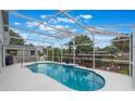 Inviting screened pool with ample seating area, perfect for relaxing and entertaining outdoors at 12401 Blue Heron Way, Leesburg, FL 34788