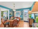 Cozy dining room with hardwood floors, a round table, and mid-century modern decor at 1301 North Ave, Tavares, FL 32778