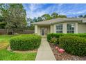 Charming single-story home with well-maintained landscaping, complemented by an inviting walkway at 13050 Se 89Th Cir, Summerfield, FL 34491