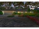 Stunning single-story home with a large garage, mature landscaping, and a charming covered entryway at 1341 W Lakeshore Dr, Clermont, FL 34711