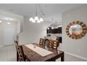 Bright dining area with a stylish table, chandelier, and an open view into the modern kitchen at 14430 Desert Haven St # 4302, Windermere, FL 34786