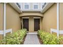 A welcoming entryway featuring dual front doors, a brick pathway, and manicured landscaping at 14430 Desert Haven St # 4302, Windermere, FL 34786