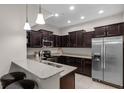Well-lit kitchen featuring stainless steel appliances, dark wood cabinetry, and a breakfast bar with seating at 14430 Desert Haven St # 4302, Windermere, FL 34786