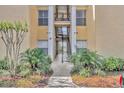 Exterior shot of building featuring landscaped walkway leading to entrance and stairs to upper units at 1460 Lake Shadow Cir # 7102, Maitland, FL 32751