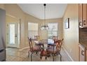 Cozy dining room features a glass table and natural light from two large windows at 2096 Callaway Dr, The Villages, FL 32162