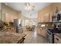 Spacious kitchen with stainless steel appliances, granite countertops and adjacent dining area at 2096 Callaway Dr, The Villages, FL 32162