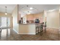 Open concept kitchen with breakfast bar, granite counters, and stainless steel appliances at 2096 Callaway Dr, The Villages, FL 32162
