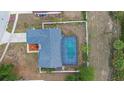 Overhead view of a screened-in pool in the home's backyard with a fenced yard at 2304 Clementine Trl, Clermont, FL 34714