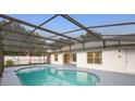 Backyard pool with a screened enclosure and paved deck at 2304 Clementine Trl, Clermont, FL 34714