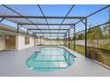 Beautiful screened-in pool area perfect for relaxation and entertainment in a private backyard setting at 2304 Clementine Trl, Clermont, FL 34714