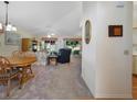 Spacious living room featuring carpet flooring, a ceiling fan, and large windows offering natural light at 239 Juniper Way, Tavares, FL 32778