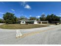 Corner lot with a single-story home and an attached two-car garage at 254 Locust Pass Dr, Ocala, FL 34472