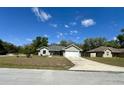 Charming single-story home with a well-maintained lawn and an attached two-car garage at 254 Locust Pass Dr, Ocala, FL 34472