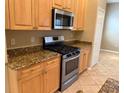 Charming kitchen featuring granite countertops and stainless steel appliances at 3083 Pinnacle Ct, Clermont, FL 34711