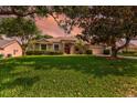 Inviting single-story home featuring mature trees and a well-maintained lawn at 3141 Brighton Rd, Eustis, FL 32726