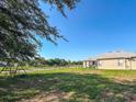 Fenced backyard with a swing set and ample green space at 33818 Venice Ln, Sorrento, FL 32776