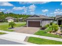 Well-maintained home featuring a paver driveway, mature landscaping, and an attached two-car garage at 503 Vigo St, Davenport, FL 33837