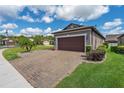Lovely home with a paver driveway, lush lawn, and well-maintained landscaping at 503 Vigo St, Davenport, FL 33837