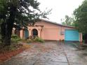 Single Gathering home featuring a covered entry way with stucco arches and a two car garage at 507 Bates Ave, Eustis, FL 32726