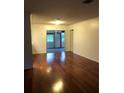 Spacious living room features gleaming hardwood floors and access to outdoor patio at 507 Bates Ave, Eustis, FL 32726