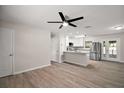 Inviting living area showcasing modern floors, an updated ceiling fan and an open-concept design at 525 Oak Dr, Tavares, FL 32778