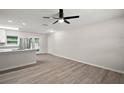 Bright living room featuring modern floors, an updated ceiling fan, and an open concept design at 525 Oak Dr, Tavares, FL 32778