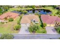 Aerial view of the beautiful home showcasing its tile roof, backyard pond, and mature landscaping at 537 Montage Ln, Kissimmee, FL 34759