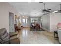 Inviting entryway with neutral color palette, tile flooring, and a bright, open dining area at 5712 Connors St, Leesburg, FL 34748