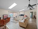 Cozy living room with natural light, fireplace, comfortable seating, and sliding glass door to the lanai at 5712 Connors St, Leesburg, FL 34748