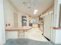 Bright kitchen features skylight, white cabinets, and functional layout at 608 Saint Andrews Blvd, Lady Lake, FL 32159