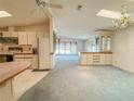 Open-concept living room and kitchen area with natural light at 608 Saint Andrews Blvd, Lady Lake, FL 32159