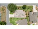 Aerial view of a well manicured home with beautiful landscaping in a tranquil residential neighborhood at 616 Hartford Ln, The Villages, FL 32162
