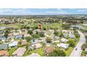 Aerial view of home with golf course in the background, offering scenic community living at 616 Hartford Ln, The Villages, FL 32162