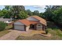Aerial view showcasing a charming home with a brick driveway and a well-maintained lawn at 6259 Se 120Th Pl, Belleview, FL 34420