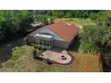 Aerial view of a backyard with a screened porch, patio and firepit sitting area at 6259 Se 120Th Pl, Belleview, FL 34420