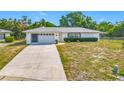 Charming single-story home with a well-maintained lawn, long drive-way and attached garage at 670 Oleander St, Mount Dora, FL 32757