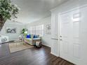 Bright living room with dark wood floors, fresh paint, large windows, decor and modern furniture at 670 Oleander St, Mount Dora, FL 32757