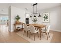 Bright dining room with modern lighting, stylish furniture, and elegant decor at 674 Anna Ridge Rd, Minneola, FL 34715